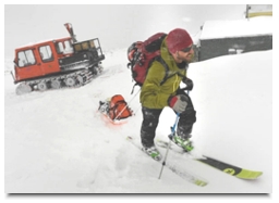Ryan Webb, a post doctoral fellow with CU and the Institute of Arctic and Alpine Research (INSTAAR), battling fierce winds and snowfall, heads towards the 2nd of 3 research stations